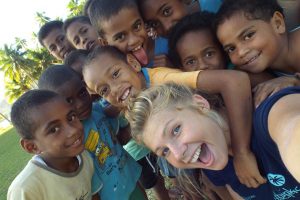 Photo of a volunteer with Fijian children